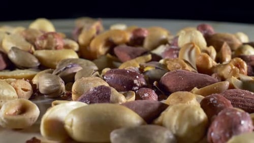 Close Up of Mixed Nuts and Hand