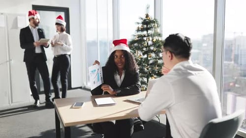 Business Team Celebrates Christmas in Bright Office