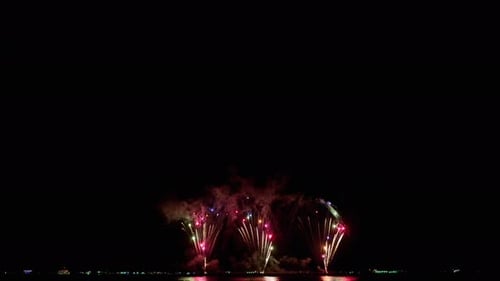 Loop seamless of real fireworks background with bokeh lights in the night sky. New year's eve firewo