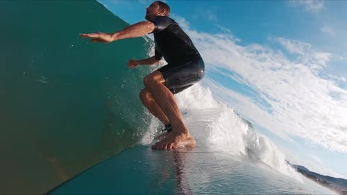 Surfer Takes Off and Rides the Ocean Waves and Carves