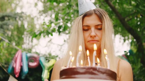 Woman with Birthday Cake Outdoors