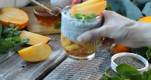Persimmon chia pudding served with fresh mint leaves
