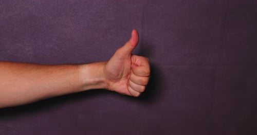 Hand Gives Thumbs Up for Agreement and Approval