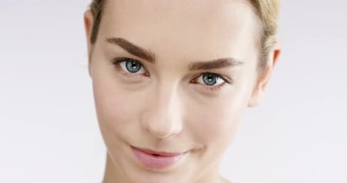 4k video footage of an alluring beautiful woman posing against a studio background