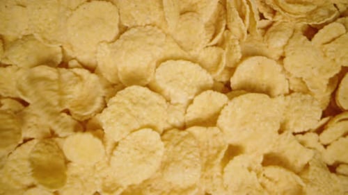 Top View of Corn Flakes Falling for Breakfast. Slow Motion. Dolly slider, close up.
