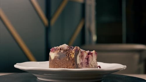 A dessert close-up of a piece of delicious cake lying on a white plate in an Italian restaurant