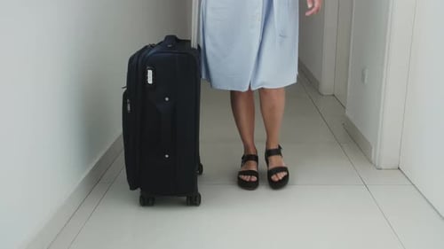 Female Legs Walking in Hotel Hall with Suitcase Tourist and Travellers Concept Vaccinated Tourist in