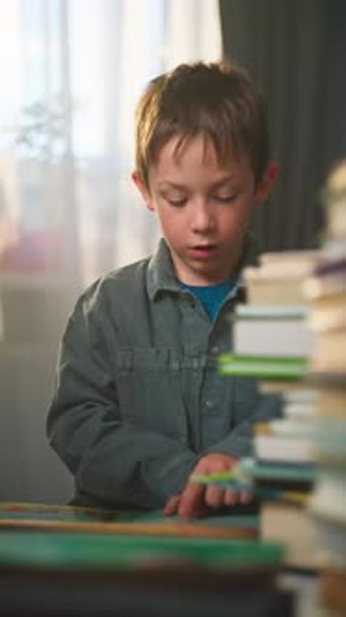 Boy Reading a Book Indoors during the Day