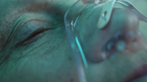 Woman with Oxygen Mask Waking Up After Coma or Surgery
