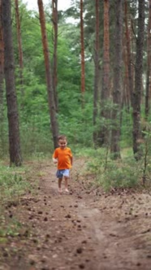 Happy Child Runs Through the Forest