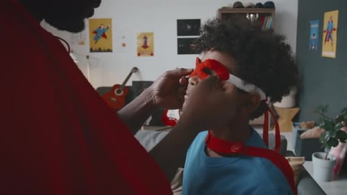 Father and Child Play Superheroes at Home