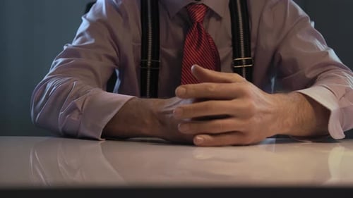 Close Up of a Businessman Hands at a Desk in an Office Wearing a Pink Shirt