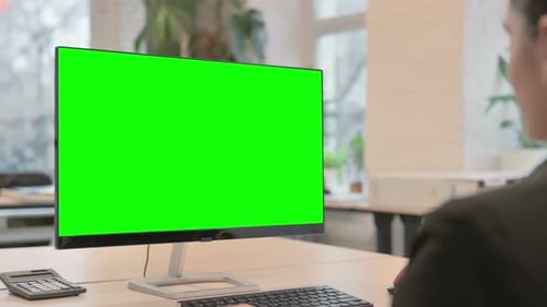 Young Businesswoman Using Chroma Key Monitor with Green Screen