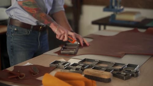 Leather Craftsman Works in His Workshop Master Making Leather Products Man Carves Leather Sheet