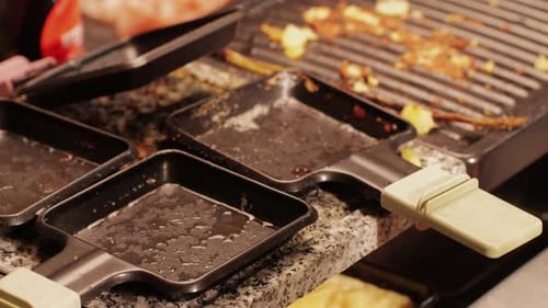 Dirty Raclette Grill and Empty Trays After Meal