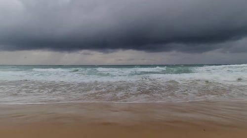 Sea Before Storm on the Beach with Waves Crashing on the Sand