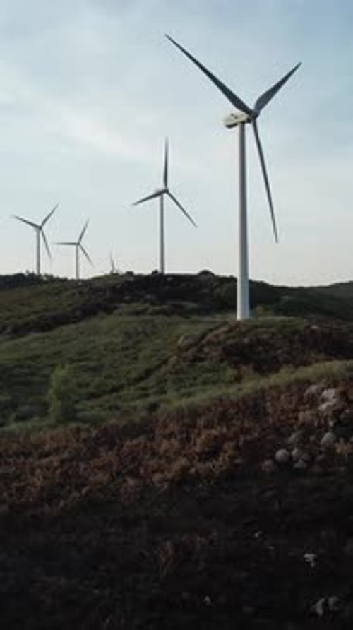 Traveling in Mountain Road with Windmills Vertical Video