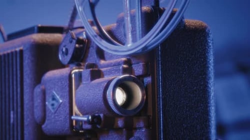Retro 8Mm Projector Playing an Old Film in a Moody Dimly Lit Room