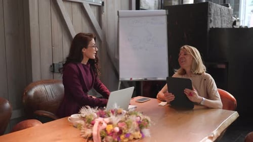 Women Collaborating in Modern Workplace Setting