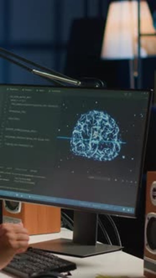 Computer Displaying Brain Graphic with Code