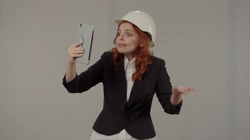 Woman Talking on Tablet Video Call Wearing Hardhat