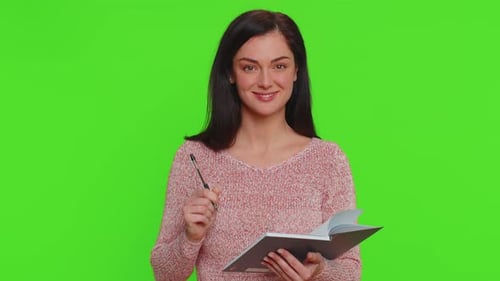 Woman Thinking and Writing in Notebook on Green Screen