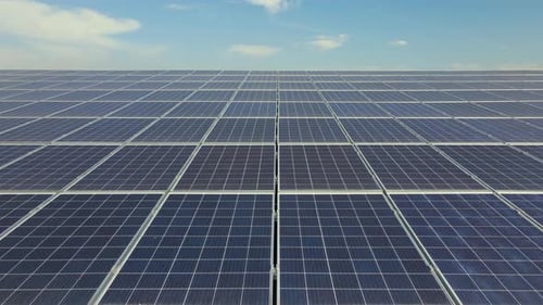 Aerial View of Surface of Blue Photovoltaic Solar Panels Mounted on Building Roof for Producing