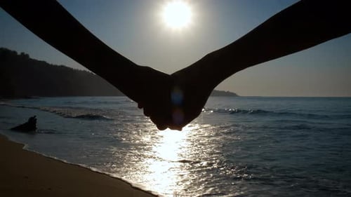 Silhouette of Giving Hand on Beach