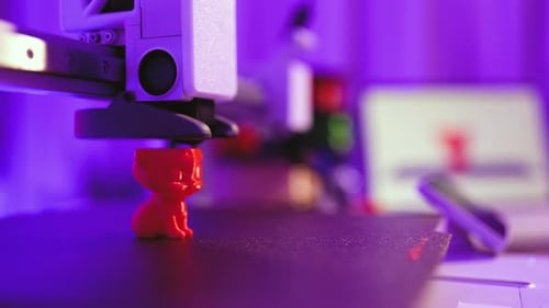3D Printer Creating Red Cat Figurine