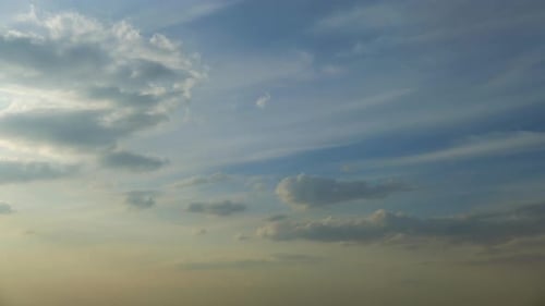 Cirrus clouds in the blue sky. timelapse. Evening clouds in the sunset sky in the light of the rays