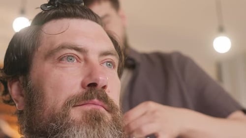 Barber Giving Haircut to Man in Salon