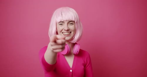 Smiling Woman with Pink Wig Pointing and Clapping