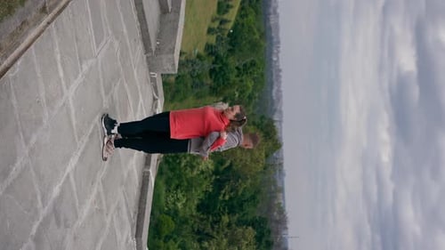 Vertical Video in the Park a Young Couple in Love Doing Sports Couples Warming Up Healthy Lifestyle