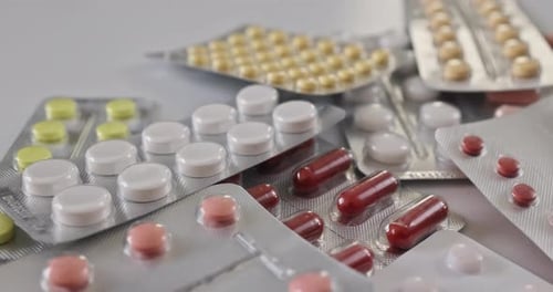 Variety of Multicolored Pills in Foil Packaging