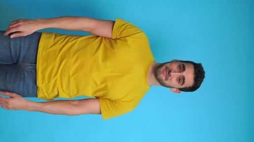 Cheerful Man Showing Thumbs Up and Pointing with Fingers