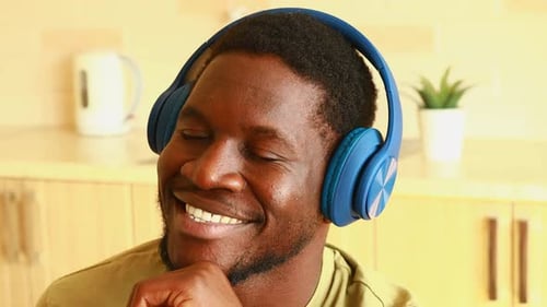 Smiling Man Listening to Music with Headphones