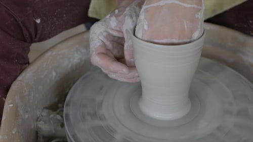 Close Up Potter Shaping Wet Clay on Pottery Wheel 3034 Years