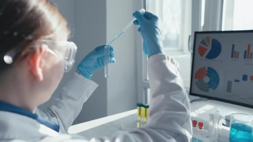 A Diligent Scientist is Conducting a Complex Experiment in a Wellequipped Lab Using a Test Tube for