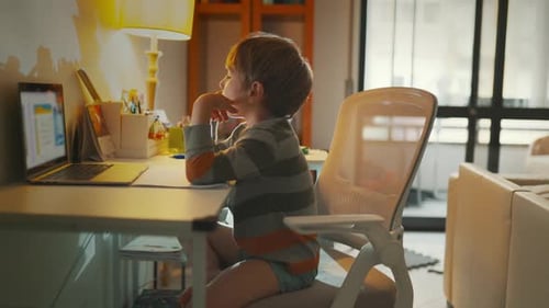 Child Learning at Desk with Computer in a Home Setting