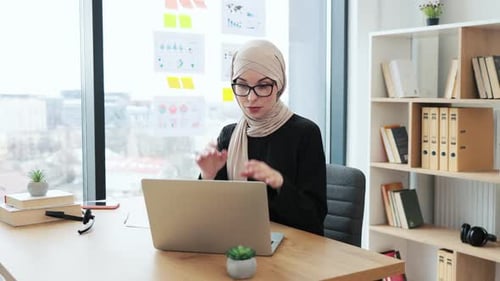Woman Working at Desk in Office with Headache