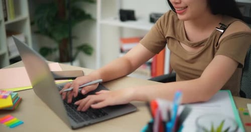 Young Adult Woman Working From Home On Computer