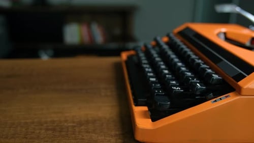 Writing letters with orange retro vintage typewriter