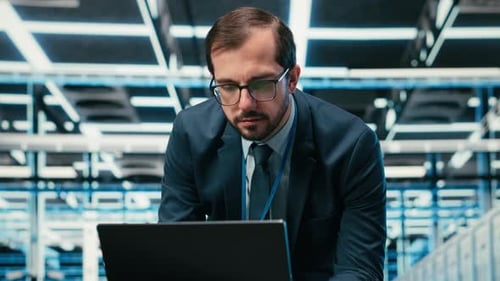 Data Center Admin Typing on Laptop Keyboard Doing Resource Optimization