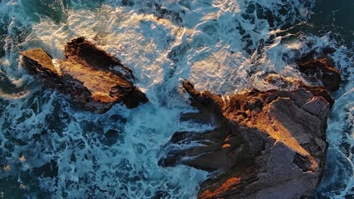 Top View of Waves and Rocks in Sea