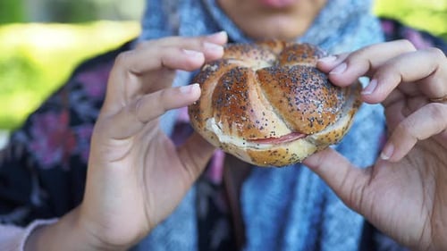 Close-Up of Poppyseed Roll Sandwich Outdoors