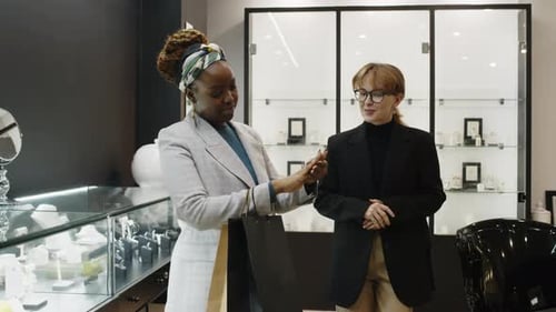 Female Salesperson Consulting Black Woman Choosing Jewellery in Shop