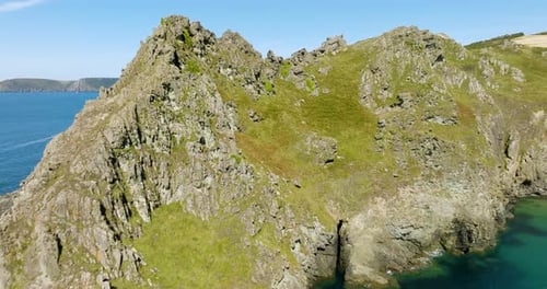 Flying Over Rocky Cliff To Reveal Spectacular Dramatic Coastline And Blue Waters