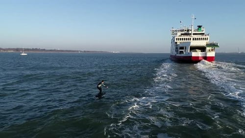 E Foil Sunset boating on the water. Paddleboard, stand-up surfing on electric foil. Aerial drone sho