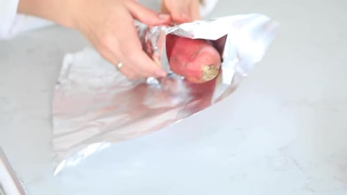Wrapping a Sweet Potato in Foil for Cooking
