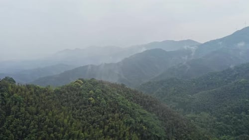 Green Mountains with Fog and Wind Turbines